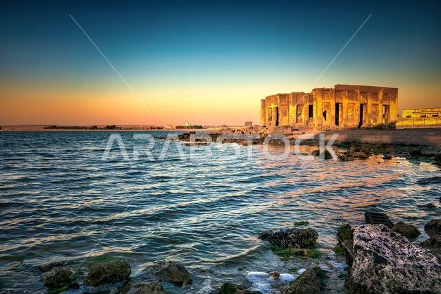 Dramatic sunrise with silky water view in Al uqair ruined fort sea side Saudi Arabia.