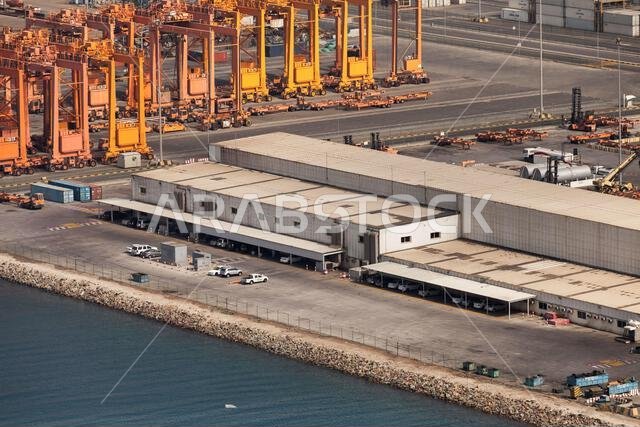 Jeddah Islamic Seaport aerial view with gantry cranes and industrial buildings at pier