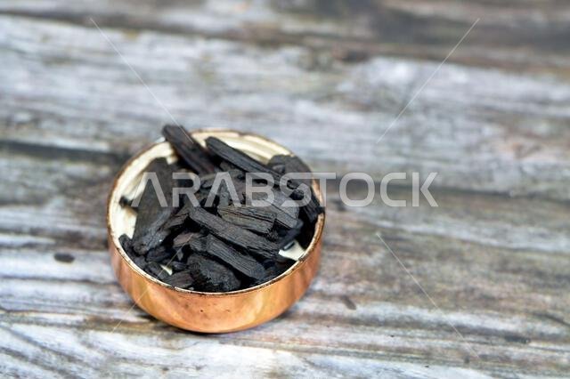 Saudi Oud incense, an aromatic biotic material that releases fragrant smoke when burnt. The term is used for either the material or the aroma, compose