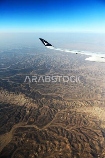 Flying with Cathay Pacific over the deserts of Jordan and Saudi Arabia.