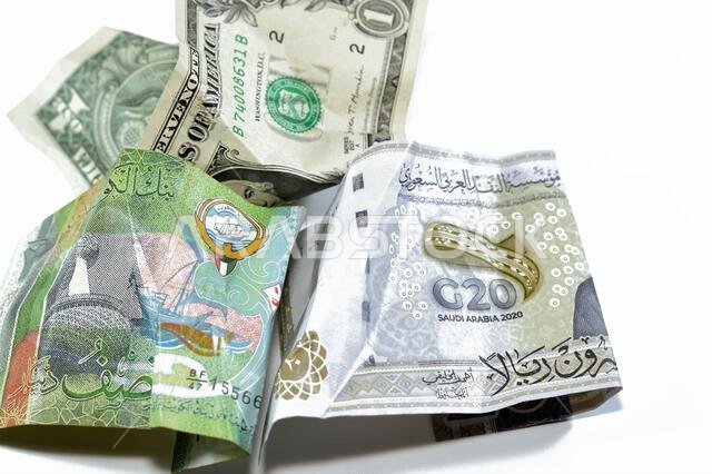 Wrinkled, crumpled Saudi Arabia, Kuwaiti half dinar money 20 SAR twenty riyals, 1 one American dollar cash, Money inflation and losing value, drop con