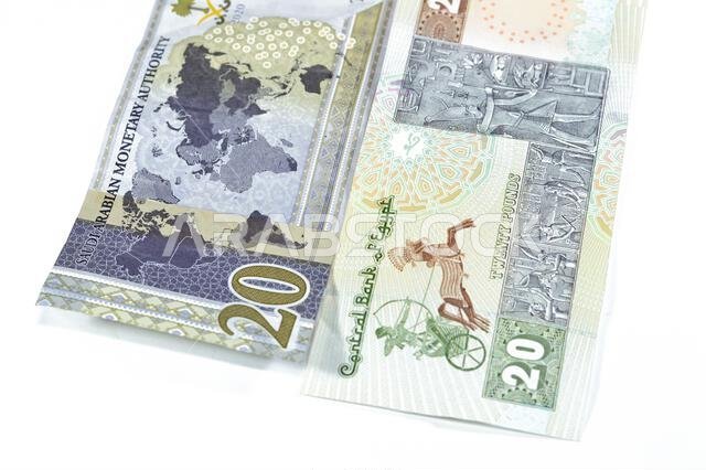 ورقة نقدية سعودية من فئة 20 ريالاً سعودياً، مع 20 جنيهاً مصرياً، وسعر صرف العملات المصرية والسعودية، وصورة لمسجد محمد علي.