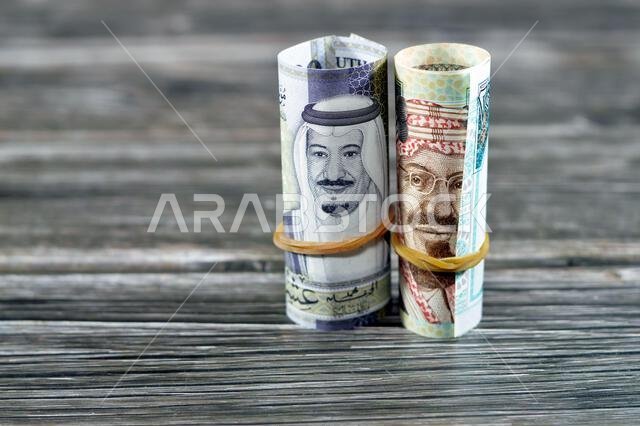 20 SAR Twenty Saudi Arabia money roll riyals banknotes, Saudi riyals cash money bills rolled up with rubber bands features images of king Salman and K