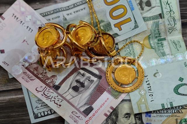 Saudi Arabia Riyals and USA USD American dollars banknotes currency bills money with sovereign British gold coins shapes bullion coin features George Saudi Arabia Riyals and USA USD American dollars banknotes currency bills money with sovereign British gold coins shapes bullion coin features George