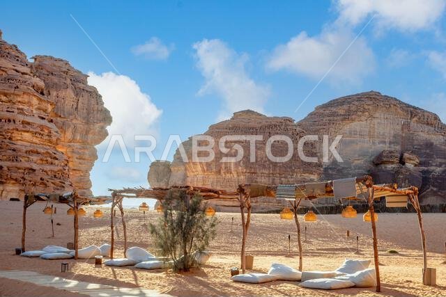 Outdoor lounge in front of elephant rock erosion monolith standing in the desert, Al Ula, Saudi Arabia
