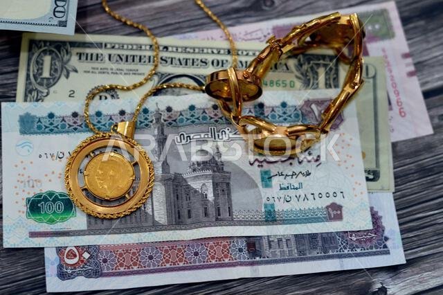 American dollars, Egyptian pounds and Saudi Arabia Riyals banknotes currency bills money with sovereign British gold coins shapes bullion coin feature
