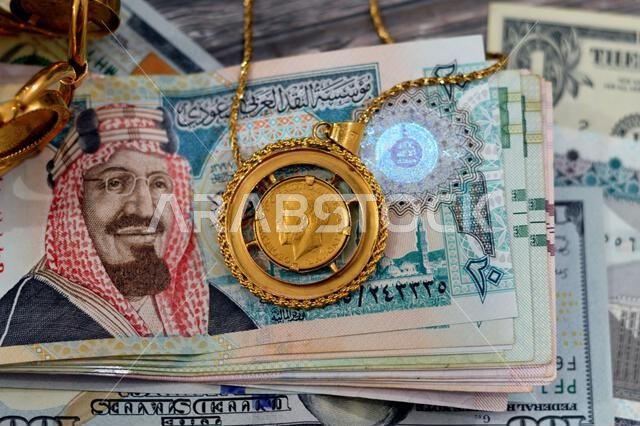 American dollars, Egyptian pounds and Saudi Arabia Riyals banknotes currency bills money with sovereign British gold coins shapes bullion coin feature American dollars, Egyptian pounds and Saudi Arabia Riyals banknotes currency bills money with sovereign British gold coins shapes bullion coin feature