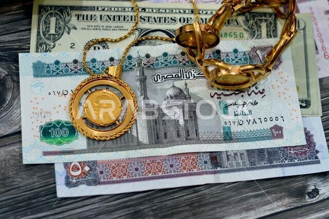 American dollars, Egyptian pounds and Saudi Arabia Riyals banknotes currency bills money with sovereign British gold coins shapes bullion coin feature