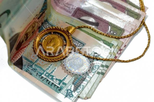 sovereign British gold coin shapes bullion coin features George and dragon Jewellery or jewelry on Saudi Arabia riyals cash money banknote, Gold price