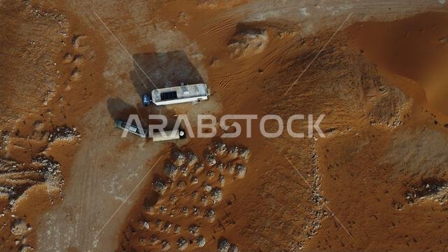 An aerial view of a white, vintage located in the desert of Saudi Arabia