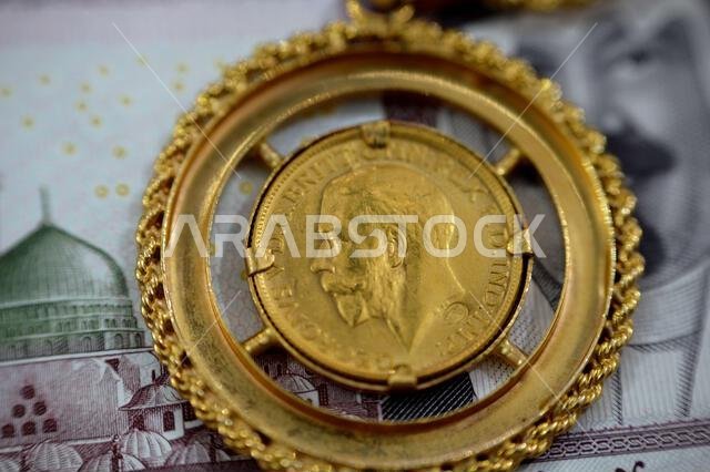 sovereign British gold coin shapes bullion coin features George and dragon Jewellery or jewelry on Saudi Arabia riyals cash money banknote, Gold price