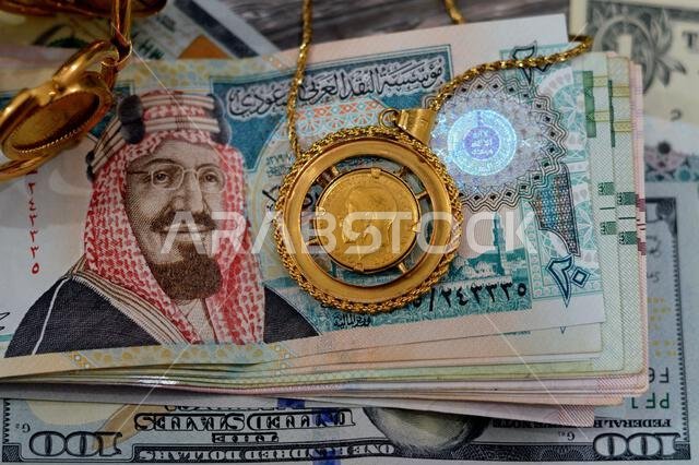 American dollars, Egyptian pounds and Saudi Arabia Riyals banknotes currency bills money with sovereign British gold coins shapes bullion coin feature American dollars, Egyptian pounds and Saudi Arabia Riyals banknotes currency bills money with sovereign British gold coins shapes bullion coin feature
