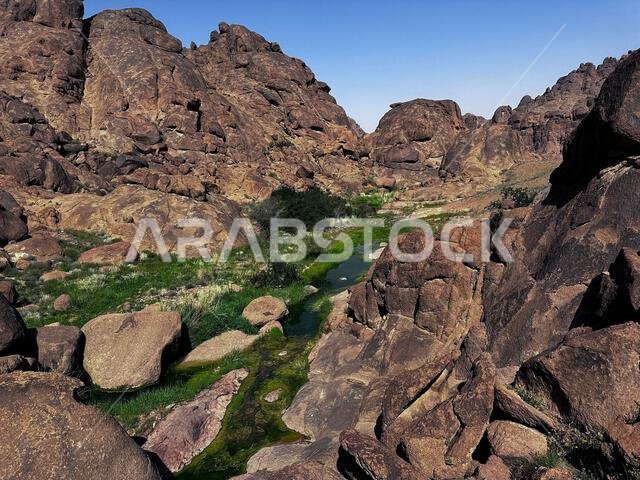 A small creek snaking through the rocky terrain in Saudi Arabia, Hail A small creek snaking through the rocky terrain in Saudi Arabia, Hail
