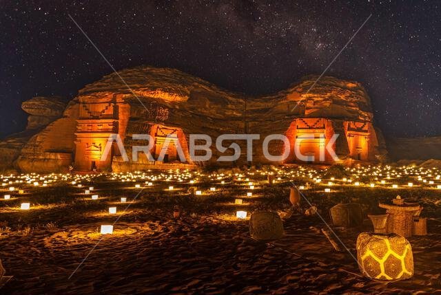 Starlight sky over the ancient nabataean tombs of Hegra city illuminated, night panorama, Al Ula, Saudi Arabia Starlight sky over the ancient nabataean tombs of Hegra city illuminated, night panorama, Al Ula, Saudi Arabia
