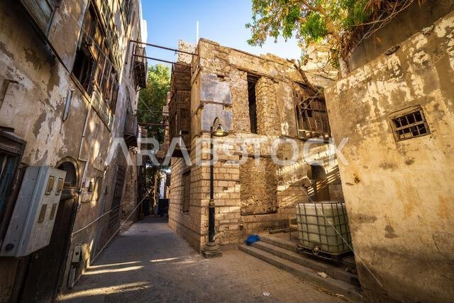 View of dilapidated residential houses in a typical side street in the historic district Al-Balad, Jeddah, KSA, Saudi Arabia
