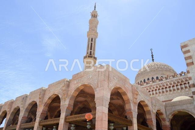 Moslem Islamic mosque of white brick for the collection of Muslims for general prayer, a liturgical architectural structure with arches, tall towers,