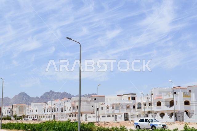 City landscape with white small square houses, cottages and townhouses on the Arab Muslim Islamic street in Egypt against a blue sky in a tropical cou City landscape with white small square houses, cottages and townhouses on the Arab Muslim Islamic street in Egypt against a blue sky in a tropical cou