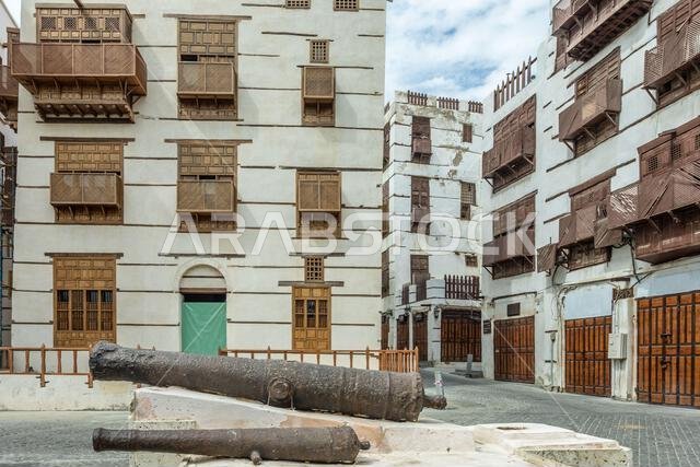 Al-Balad old town with traditional muslim houses and old cannons in the foreground, Jeddah, Saudi Arabia