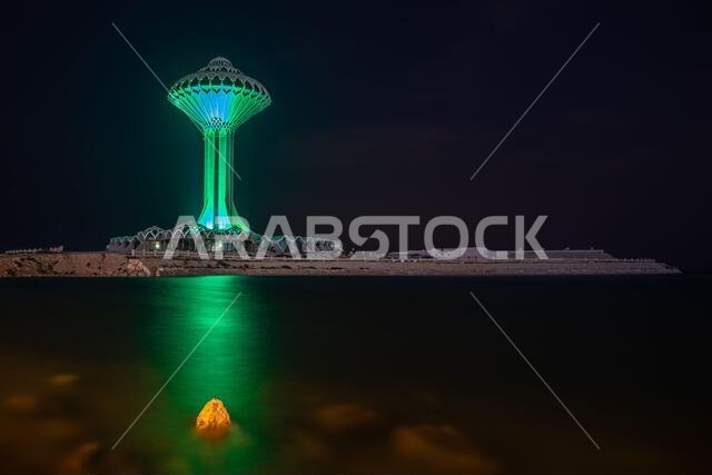 Al Khobar water tower illuminated in green during the night on the sea shore, Dammam, Saudi Arabia