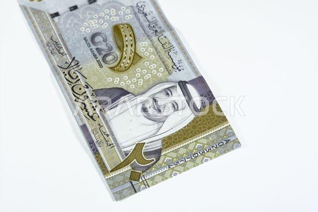 Obverse side of 20 SAR twenty Saudi Arabia Riyals banknote currency bill money Commemorative issue with portrait of king Salman , 3D logo of the Kingd