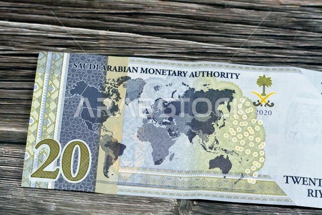 Reverse side of 20 SAR twenty Saudi Arabia Riyals banknote currency bill money Commemorative issue with a map of the world depicting G20 summit countr