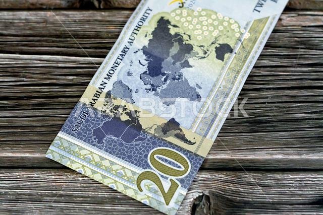 Reverse side of 20 SAR twenty Saudi Arabia Riyals banknote currency bill money Commemorative issue with a map of the world depicting G20 summit countr