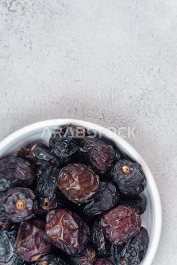 Raw Organic Arabic Dates, Ajwa Dates on light gray background. Ramadan Kareem. Close up.