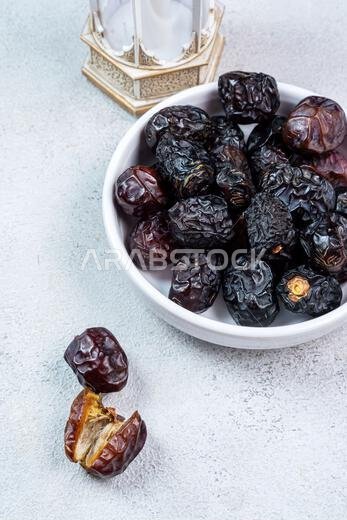 Raw Organic Arabic Dates, Ajwa Dates on light gray background. Ramadan Kareem. Close up.