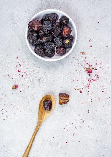 Raw Organic Arabic Dates, Ajwa Dates on light gray background. Ramadan Kareem. Top View.