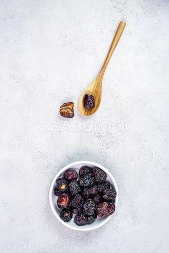 Raw Organic Arabic Dates, Ajwa Dates on light gray background. Ramadan Kareem. Top View.