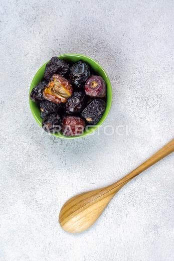 Raw Organic Arabic Dates, Ajwa Dates on light gray background. Ramadan Kareem. Top View.