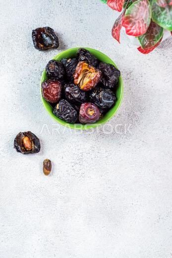 Raw Organic Arabic Dates, Ajwa Dates on light gray background. Ramadan Kareem. Top View.