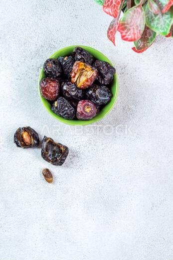 Raw Organic Arabic Dates, Ajwa Dates on light gray background. Ramadan Kareem. Top View.
