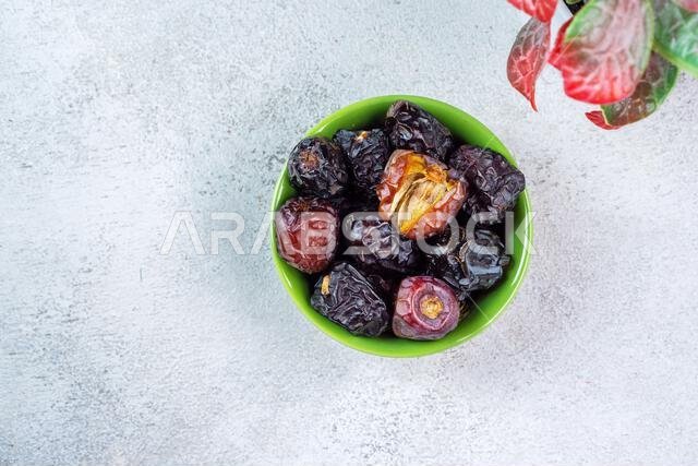 Raw Organic Arabic Dates, Ajwa Dates on light gray background. Ramadan Kareem. Top View.