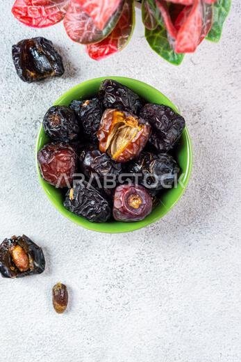 Raw Organic Arabic Dates, Ajwa Dates on light gray background. Ramadan Kareem. Top View.