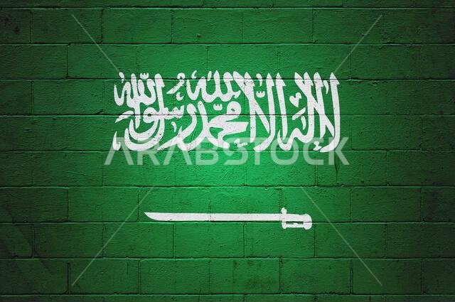 Flag of Saudi Arabia painted on a cinder block wall.