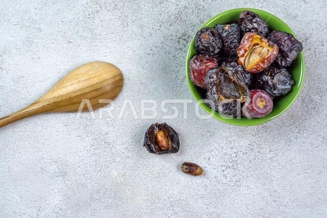 Raw Organic Arabic Dates, Ajwa Dates on light gray background. Ramadan Kareem. Top View.