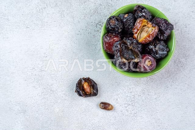 Raw Organic Arabic Dates, Ajwa Dates on light gray background. Ramadan Kareem. Top View.