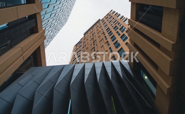 صورة ابداعية بزاوية سفلية لمركز الملك عبدالله المالي ( كافد ) في الرياض بالمملكة العربية السعودية، الأبراج وناطحات السحاب، معالم الرياض المشهورة، الفن الهندسي المعماري بالسعودية، السياحة في السعودية