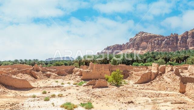 Al Ula ruined old town street with palms and rocks int the background, Saudi Arabia