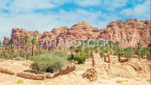 Al Ula ruined old town street with palms and rocks int the background, Saudi Arabia
