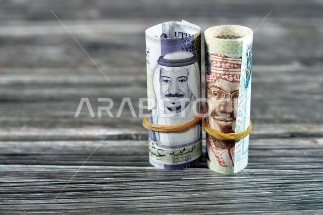 20 SAR Twenty Saudi Arabia money roll riyals banknotes, Saudi riyals cash money bills rolled up with rubber bands features images of king Salman and K