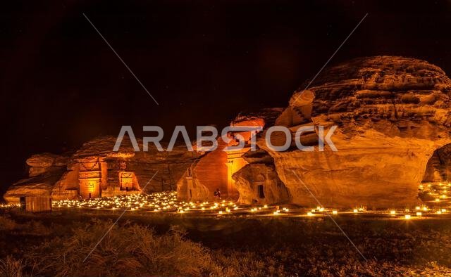 Ancient tombs of Hegra city illuminated during the night panorama, Al Ula, Saudi Arabia
