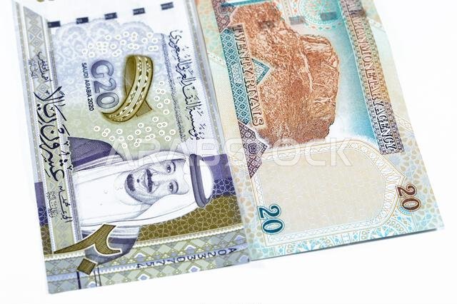 20 SAR twenty Saudi Arabia Riyals banknotes currency bill money an old one with king AbdulAziz photo, Quba Mosque, light mountain and new one with Kin
