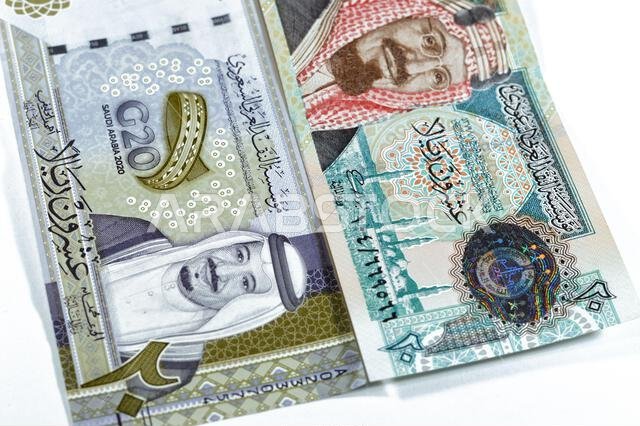 ٢٠ ريالاً سعودياً، عملة ورقية قديمة عليها صورة الملك عبد العزيز ومسجد قباء وجبل النور، وعملة جديدة عليها صورة الملك