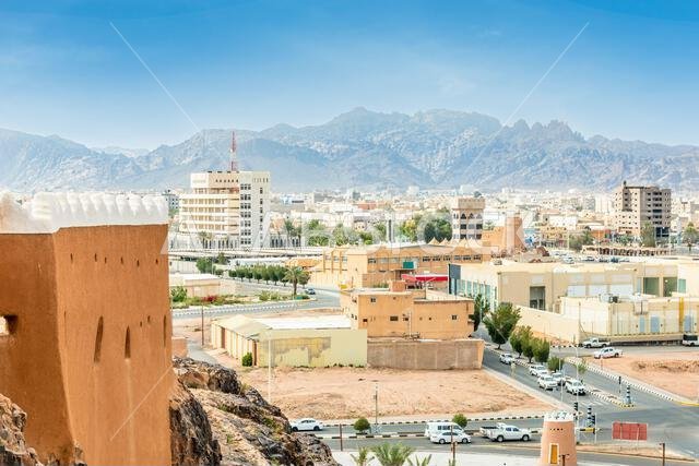 Hail city downtown and walls of Arabian Aarif fortress standing on the hill, Hail, Saudi Arabia