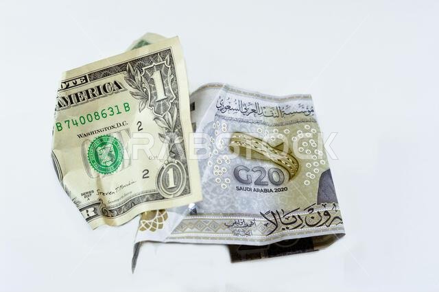 Wrinkled and crumpled Saudi Arabia money of 20 SAR twenty riyals and 1 one American dollar cash money, Money inflation and losing value, drop concept,