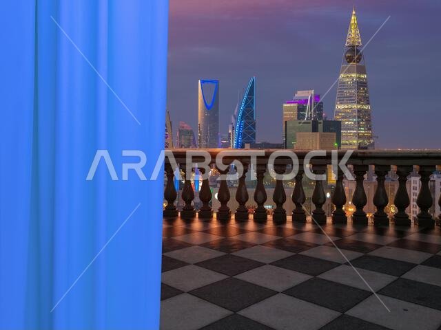 A view of Riyadh city, Saudi Arabia from a terrace (balcony) of a high building from inside the room showing a white beautiful curtains.