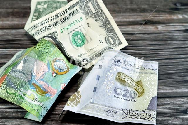 Wrinkled, crumpled Saudi Arabia, Kuwaiti half dinar money 20 SAR twenty riyals, 1 one American dollar cash, Money inflation and losing value, drop con