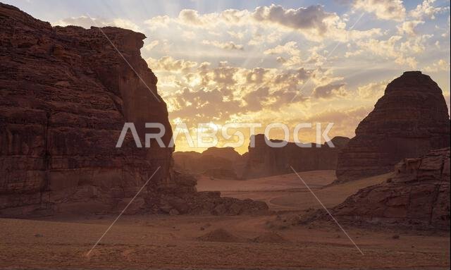 Morning sun shines over rocky desert formations, typical landscape in Al Ula, Saudi Arabia.